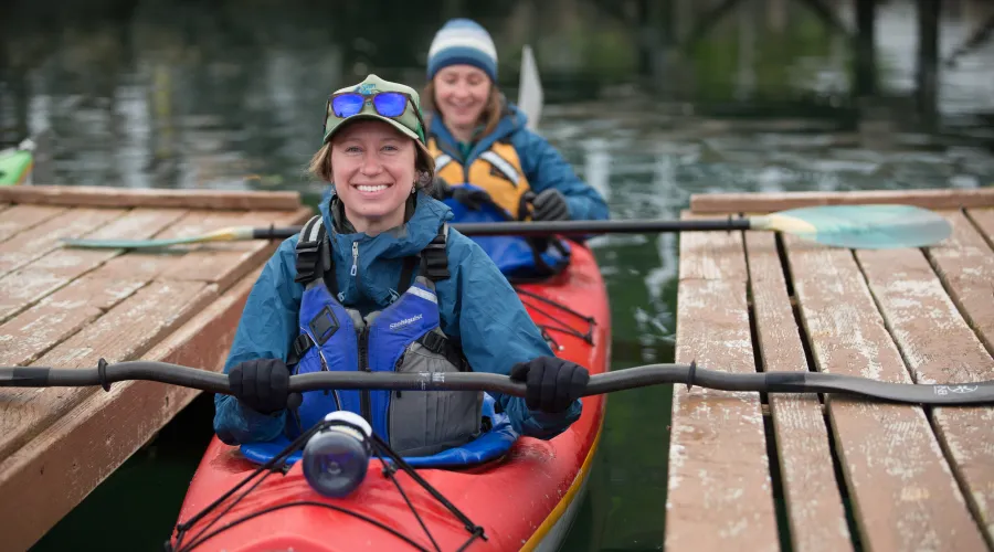 Two guests getting ready to depart for their kayak tour