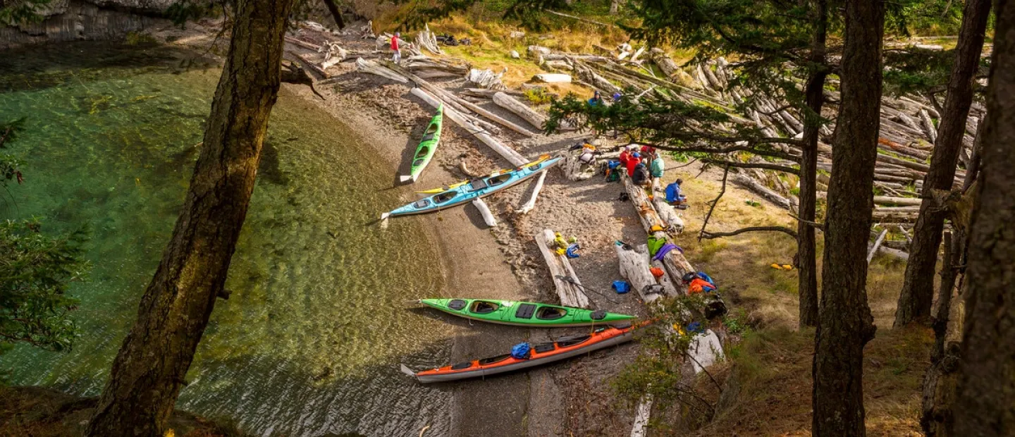 Kayaks on the shore of the San Juan Islands ready for their camping adventure