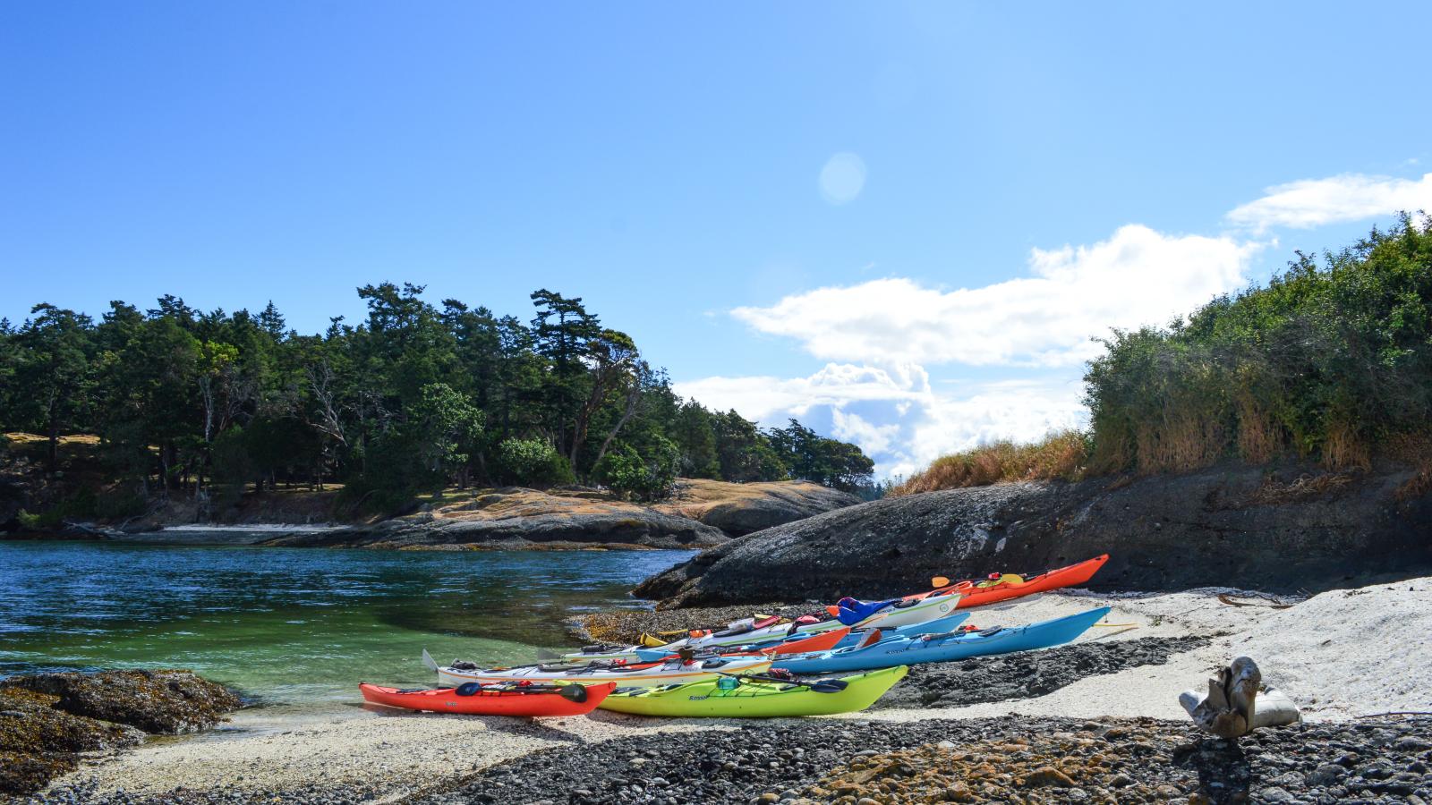 Kayaks on the shore of Gossip Island, where we stop for lunch on our paddle to Stuart